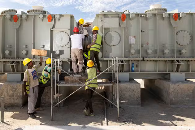 Workers from Manono Lithium work on the construction site of an electrical transformer that will power the lithium processing plant under construction in Manono, May 22, 2025.